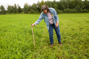 woman inspects pasture land; photo by Edwin remsberg, USDA