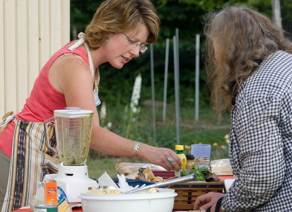Extension staff demonstrates how to cook for crowds; photo by Edwin Remsberg