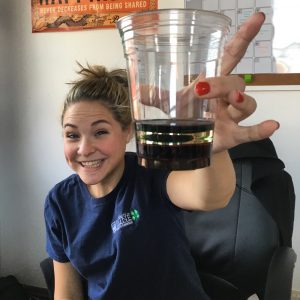 Maisy holding cup with fluids stacked by density