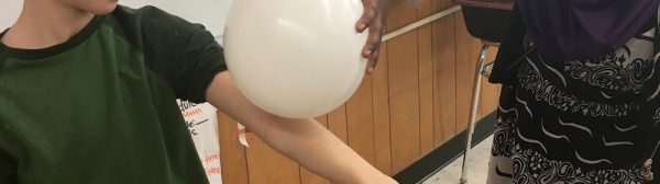 two fourth graders seeing static electricity at work