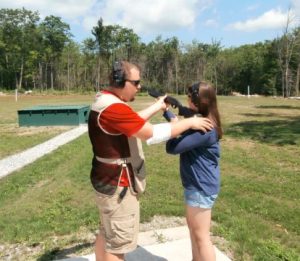shooting instructor on range with student