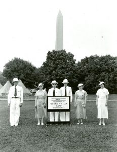 Maine delegation attending the 10th National 4-H Club Camp in 1936; Washington Monument and tents in the background