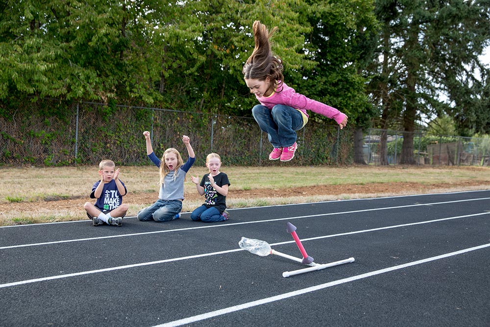 elementary school children using elements from a 4H rocket project kit
