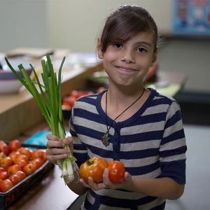 girl holding fresh vegetables
