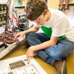 boy working on robotics project