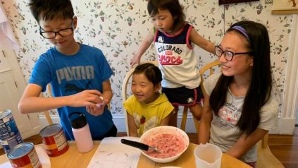 a family of children learning how to cook during a virtual learning session