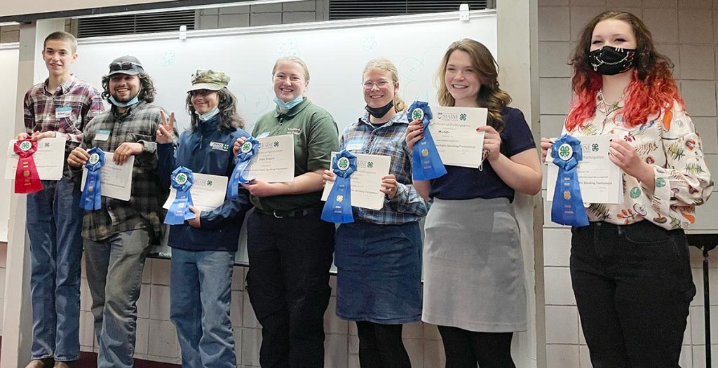 Seniors Group holding certificates and ribbons won during the 4-H Public Speaking event 2022