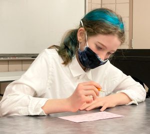 teenage presenter filling out a questionnaire before giving a presentation, 4-H Public Speaking event, 2022