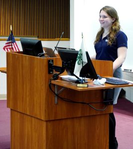 teenager presenting a speech at a podium, 4-H Public Speaking event 2022