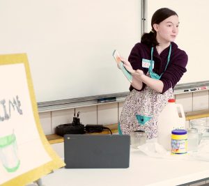 teenager giving a presentation on how to make "slime," 4-H Public Speaking event, 2022