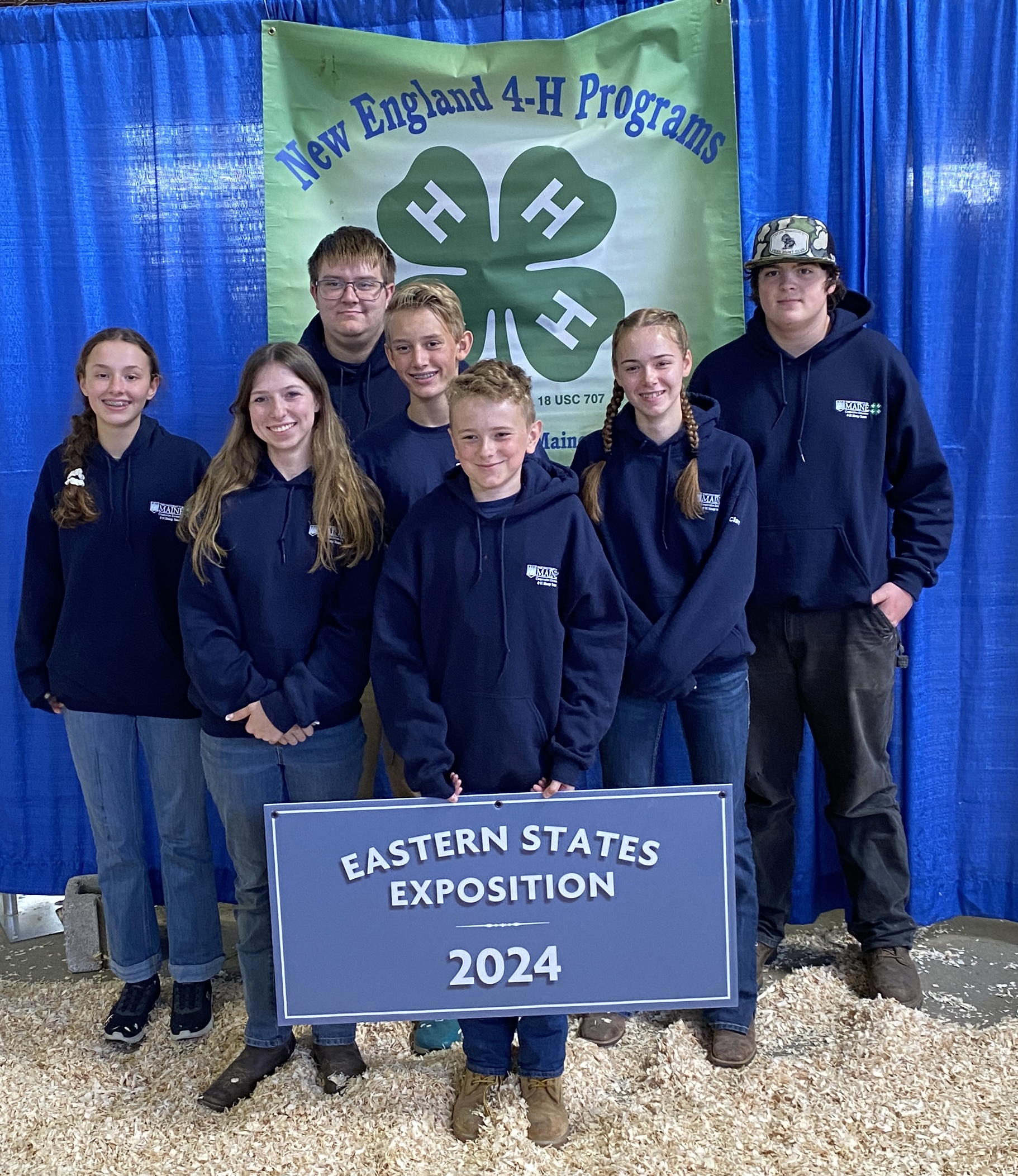 2024 Maine 4-H ESE Sheep Team posing together with a 4-H flag.