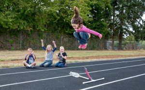 4-H youngsters conducting a rocket experiment on an outdoor track