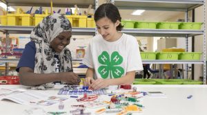 two teenage 4-H members working on a STEM activity