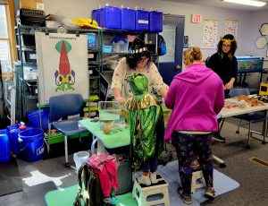 staff and youth with touch tank