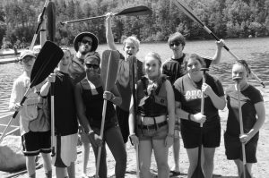 group of 4-H'ers on the dock with canoe paddles