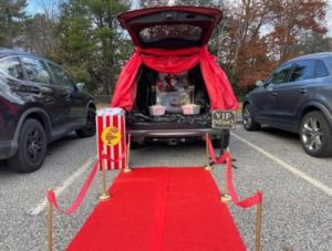 a car with its trunk open set up to look like a movie premiere