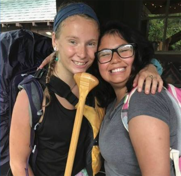 two teen 4-H campers with a canoe paddle