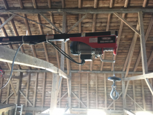 electric hoist mounted in the top loft of a barn