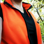 woman wearing tshirt and blaze orange fleece vest