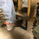 foot stepping onto tractor step