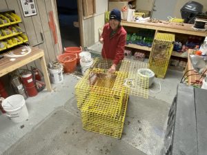 lobsterman repairing traps in a workshop