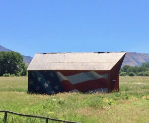barn in field painted with american flag on the side