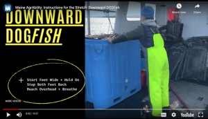 person leaning onto a blue bin to stretch their back on a boat