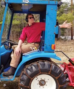 person demonstrating seated twist in a tractor