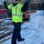 man demonstrating standing twist with long handled tool