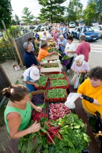 volunteers distribute fresh produce to hungry Mainers