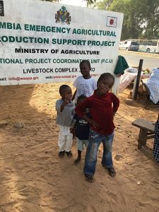 Kids pose in front of a Ministry of Agriculture sign in The Gambia