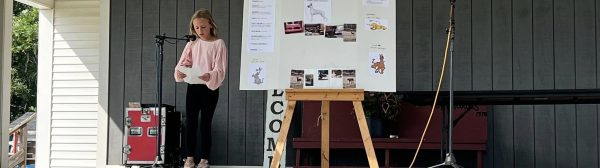 A youth giving a presentation on a stage