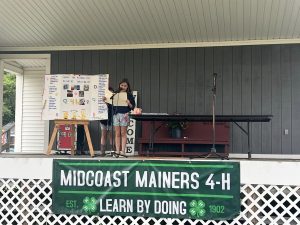 A youth giving a presentation on a stage