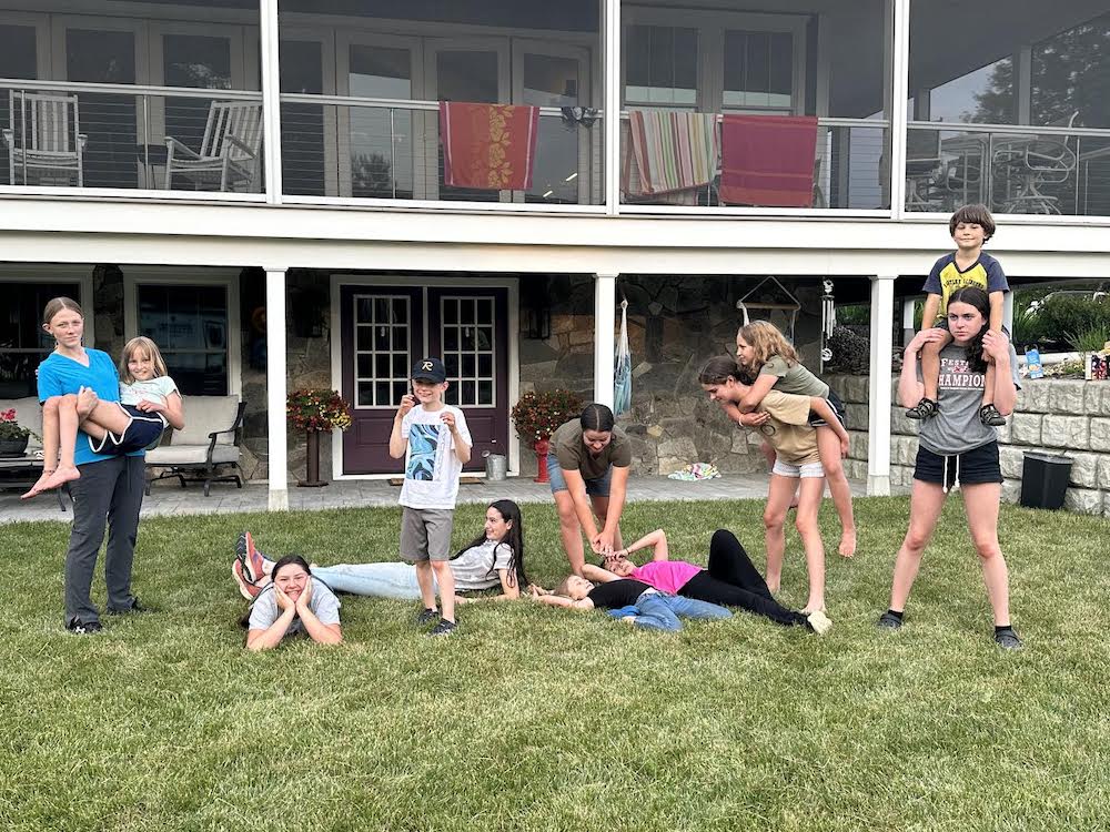 Midcoast Mainers posing on a lawn in front of a house.