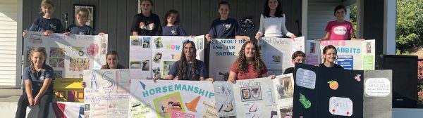 Midcoast Mainers posing with their public speaking posters.