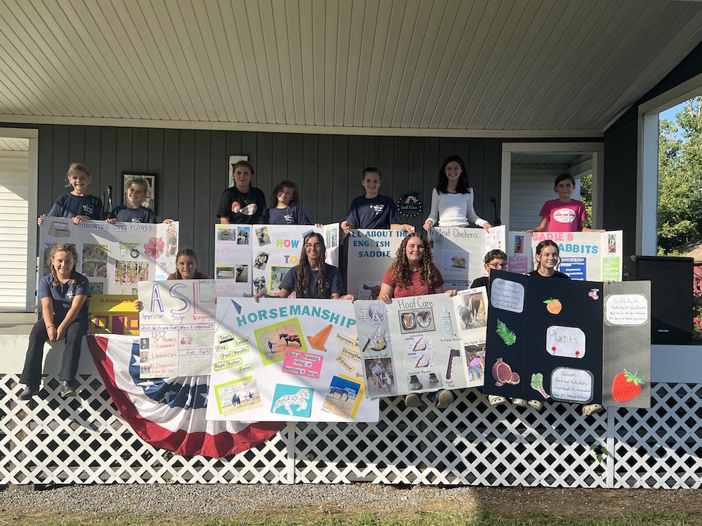 Midcoast Mainers posing with their public speaking posters.