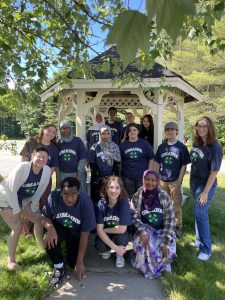 Summer of science teen teachers and interns wearing UMaine 4-H tee shirts and posing in front of a gazebo.