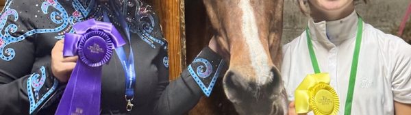 Two Midcoast Mainers posing with a horse and their award ribbons.