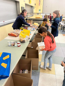 Midcoast Mainers members packing boxes with food.