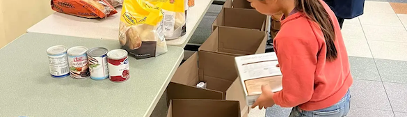 Midcoast Mainers members packing boxes with food.