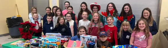 Midcoast Mainers members posing with gifts.