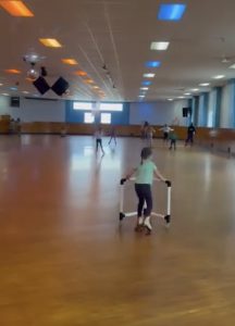 Kids roller skating at an indoor rink