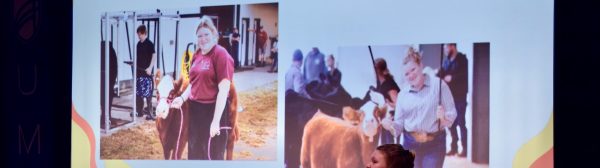 A teen presenting in front of a slideshow that reads "What is a show heifer?"