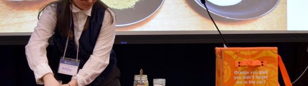 A teen performing a presentation on making henna paste.