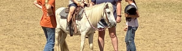 Midcoast Mainers leader and members gathered around a horse