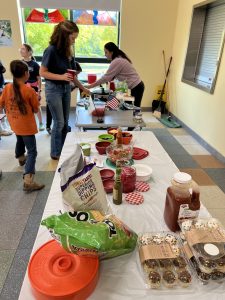Midcoast Mainers lining up for snacks at a table