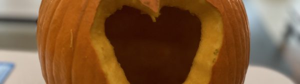 Pumpkin with a heart shape carved into it.