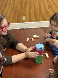 An adult and child playing jenga.