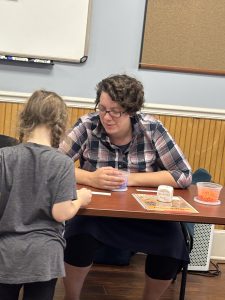 An adult and child doing crafts.