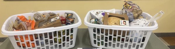 Two laundry baskets filled with donated foods.